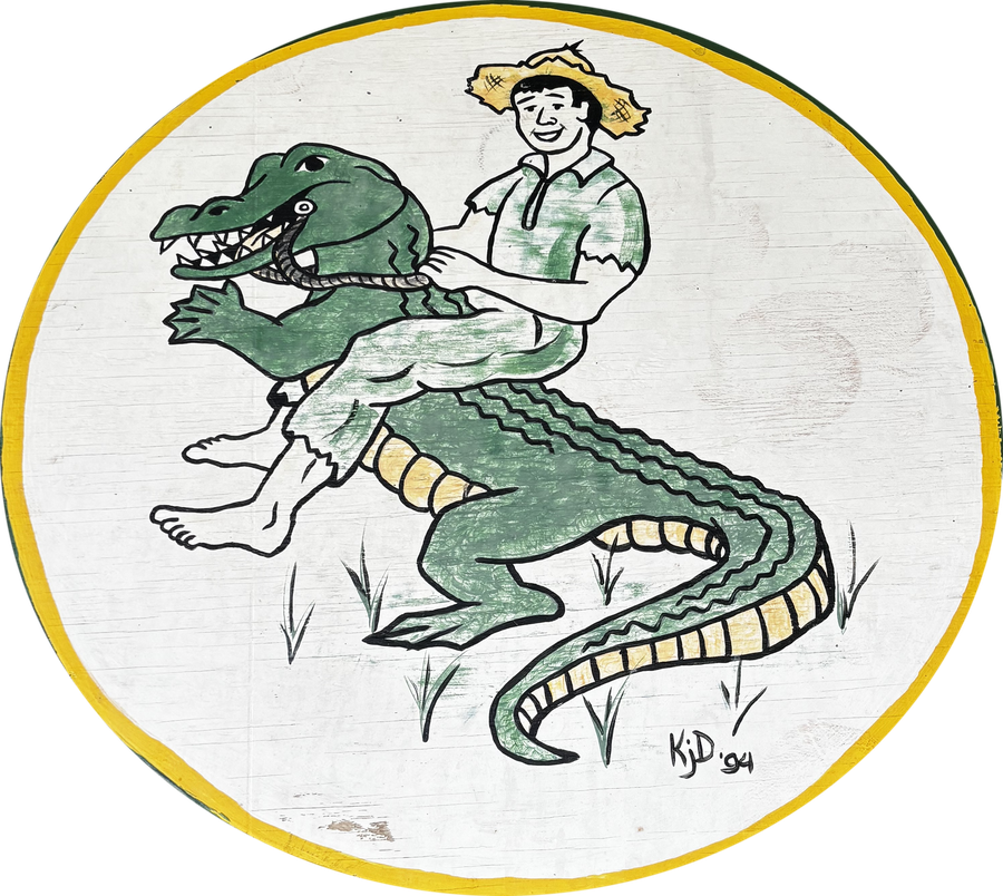 The 1994 hand-painted Sixth Ward Cajuns emblem: a boy in a straw hat riding an alligator