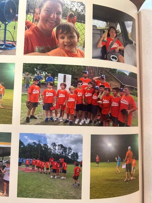 An open photo album page holding printed snapshots of a team in orange shirts