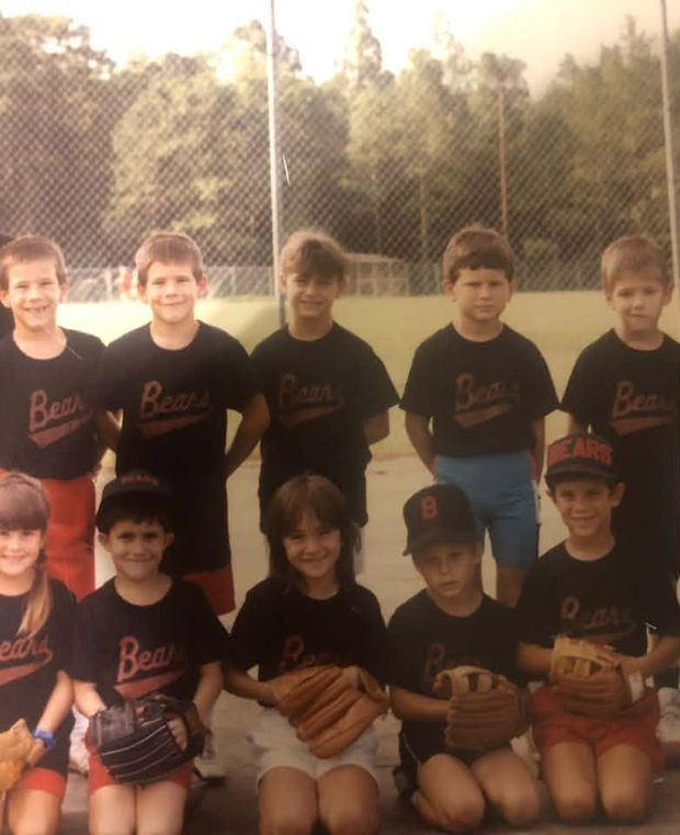 An old film print of a team in black Bears shirts posed in two rows