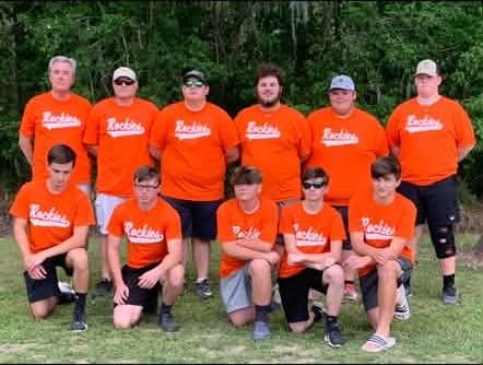 A team in orange Cajuns shirts posed in two rows