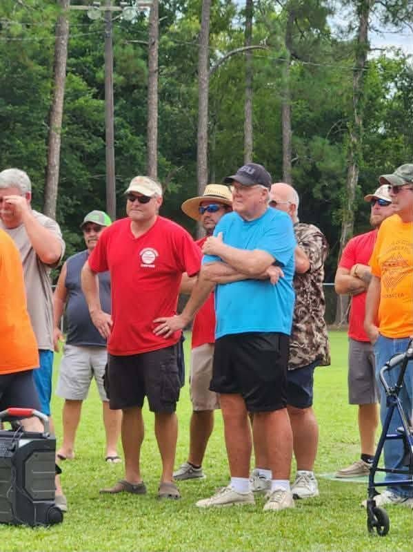 A group of men standing together on the field at the dedication