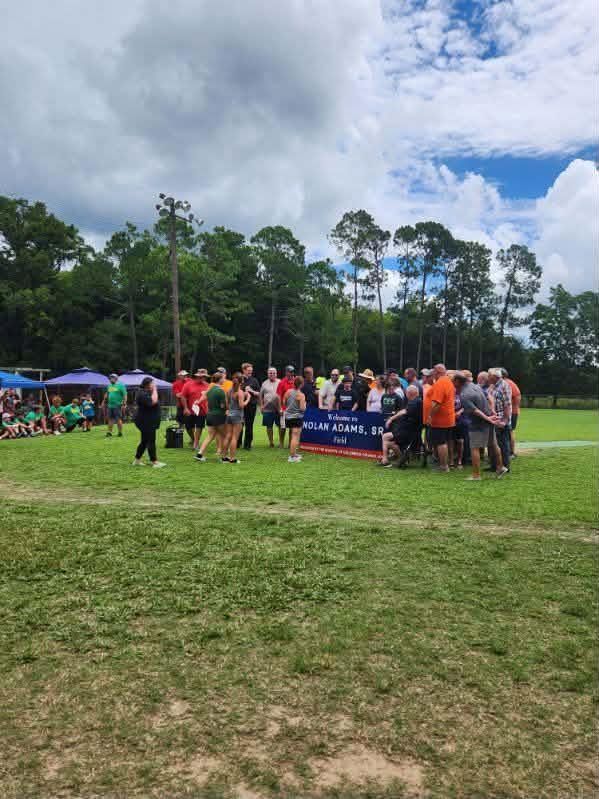 A wide view of the crowd gathered on the field for the dedication