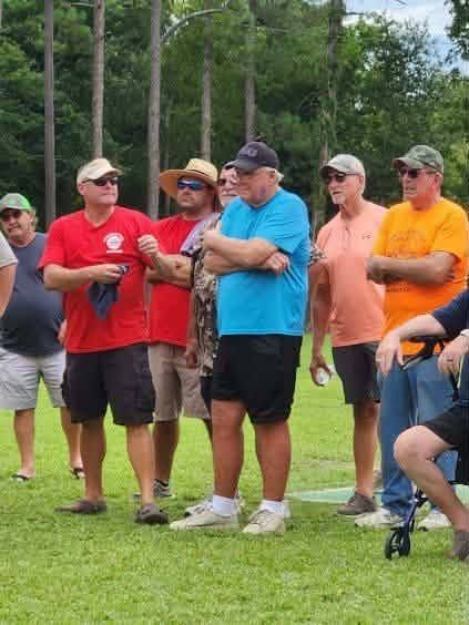 A crowd of attendees standing together at the field dedication