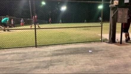 The field and dugouts under the lights at night