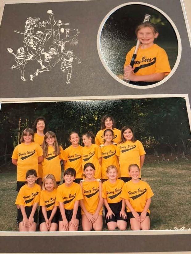 A matted print holding a team photograph of girls in yellow Honey Bees shirts and a small round portrait