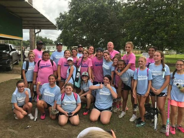 Players from two teams in pink and light blue shirts gathered in one group