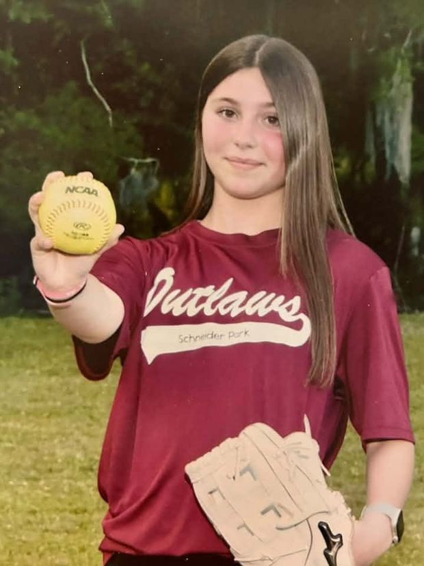 A printed portrait of a girl in a maroon Outlaws shirt holding a softball toward the camera