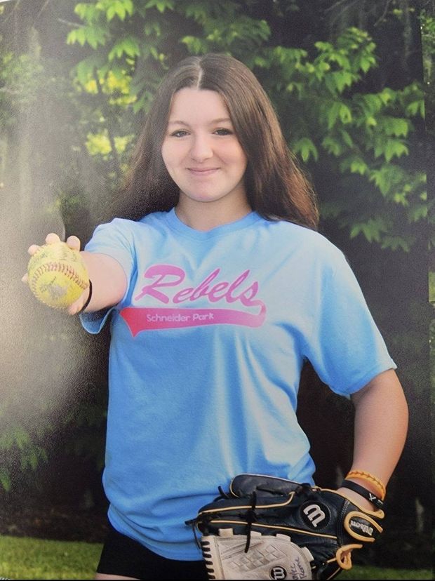 A printed portrait of a girl in a light blue Rebels shirt holding out a softball