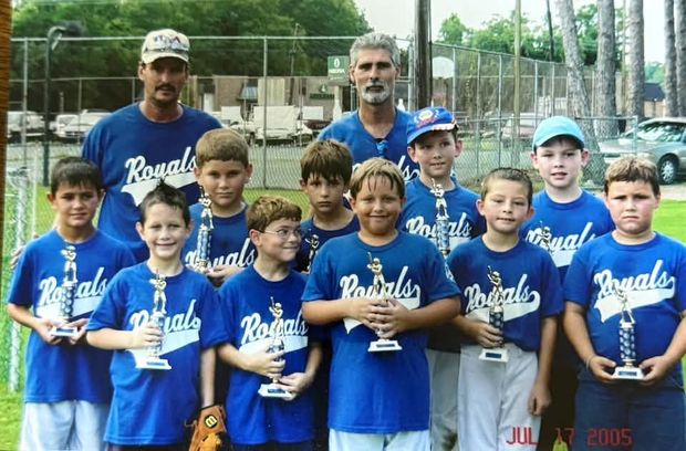 A team in blue Royals shirts holding trophies, with a July 2005 camera datestamp in the frame